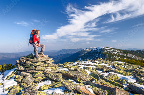 Hiker girl with backpack  in a mountains