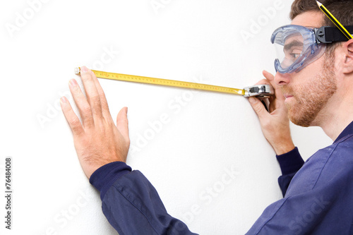 Man measuring a wall