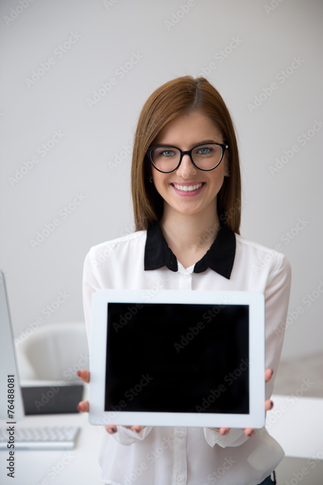 Smiling businesswoman showing tablet computer screen Smiling businesswoman showing tablet computer screen