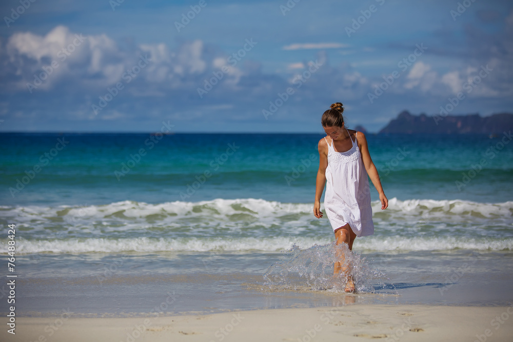 Caucasian woman rests at beautiful seashore Caucasian woman rests at beautiful seashore