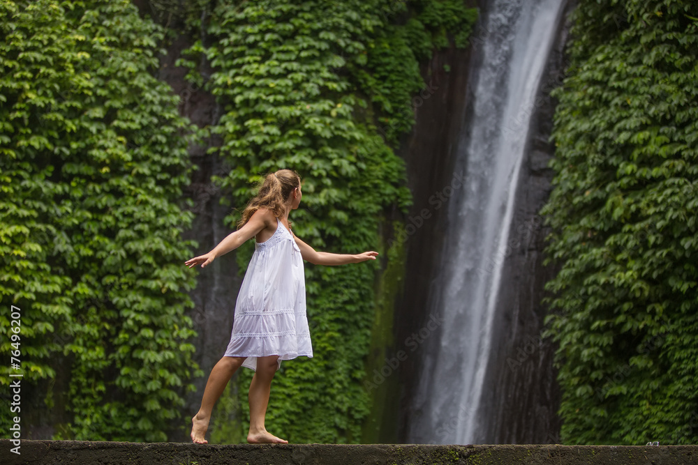 woman meditating doing yoga between waterfalls woman meditating doing yoga between waterfalls