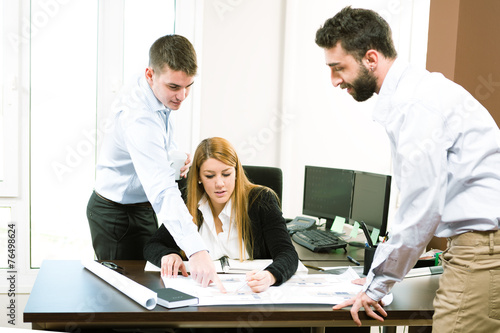 Young business people discuss the new project at office