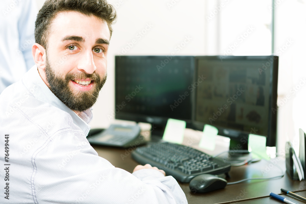 Handsome business man smiling at the office Handsome business man smiling at the office