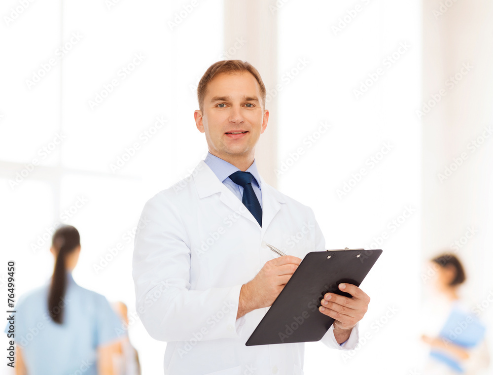 smiling male doctor with clipboard smiling male doctor with clipboard