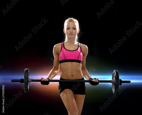 sporty woman exercising with barbell