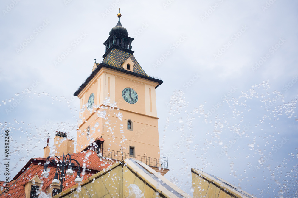 Brasov clock tower with water droplets from the fountain