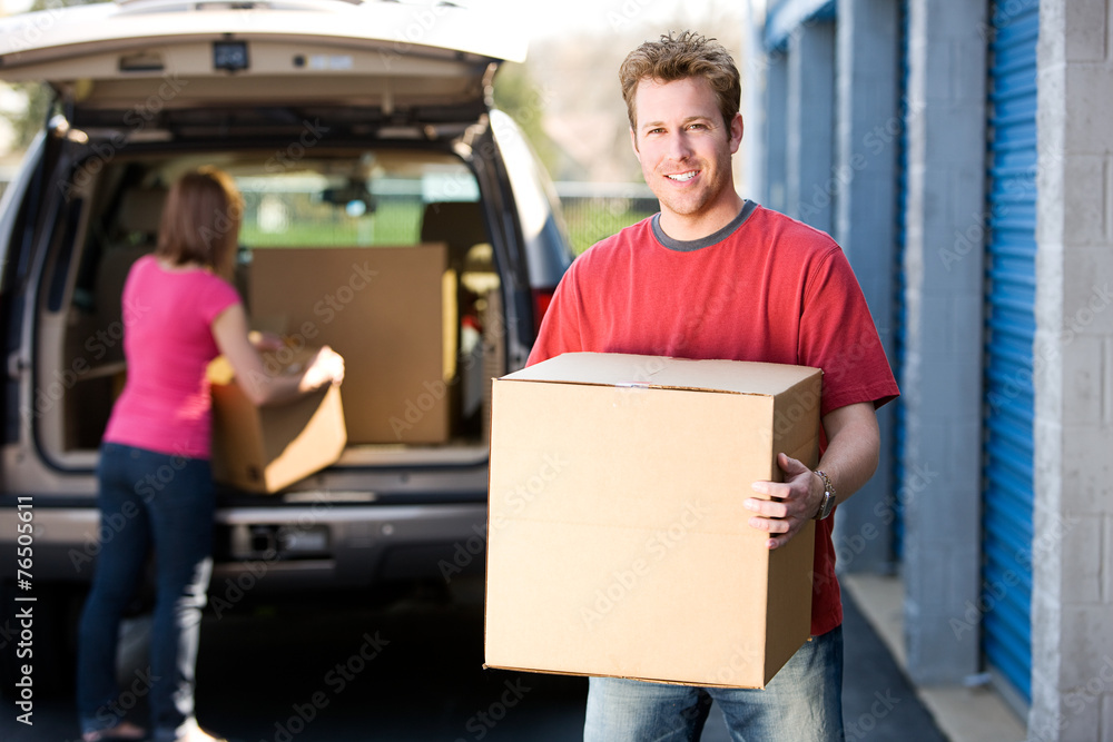 Storage: Man Holding Box with Woman Behind Storage: Man Holding Box with Woman Behind