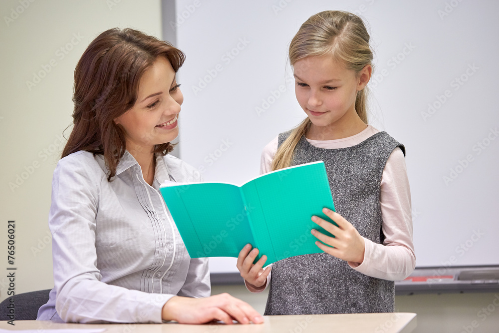 school girl with notebook and teacher in classroom school girl with notebook and teacher in classroom