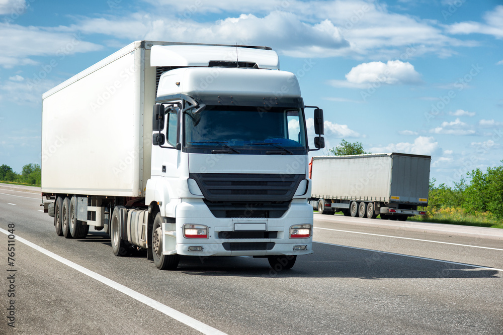 White truck on road. Cargo transportation White truck on road. Cargo transportation