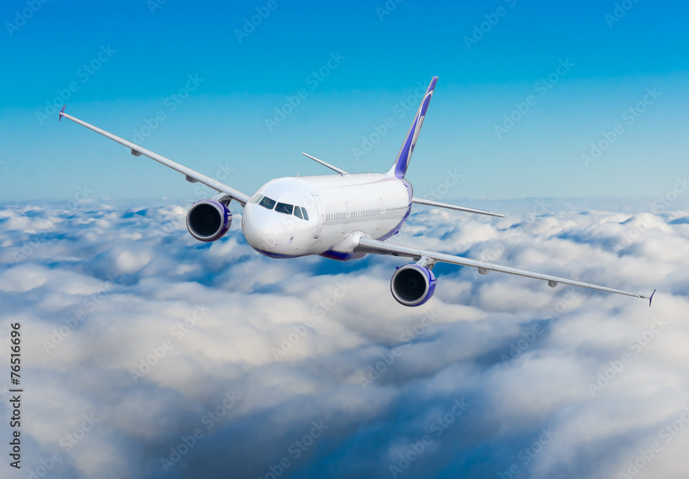 Passenger airplane flying above dramatic clouds Passenger airplane flying above dramatic clouds