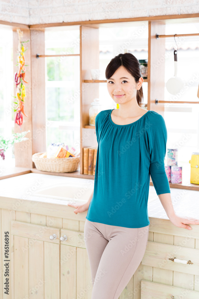 young asian woman in the kitchen young asian woman in the kitchen