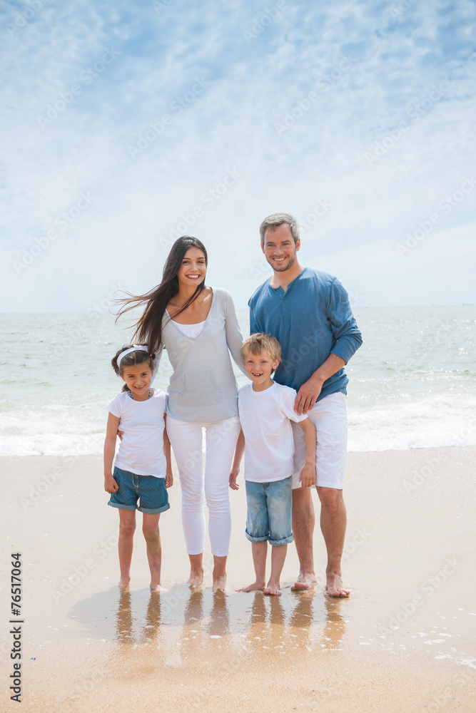 Portrait of a happy family standing on the beach Portrait of a happy family standing on the beach