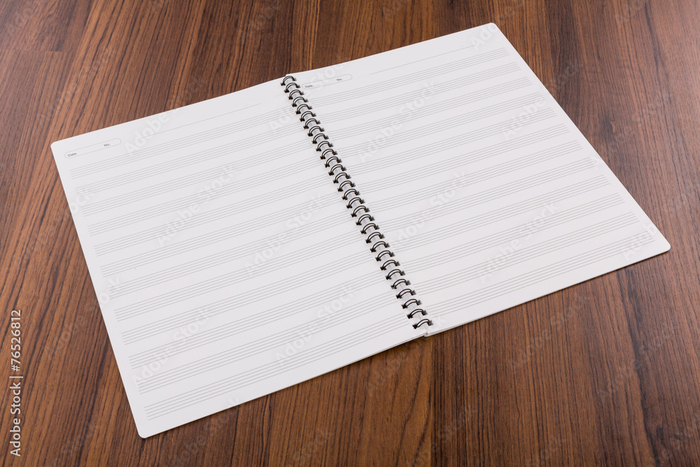 Blank musical notes book mock up on wood background Blank musical notes book mock up on wood background