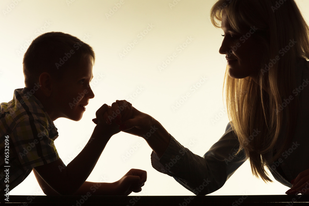  Mother and son arm wrestling.