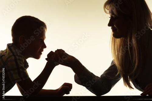  Mother and son arm wrestling.
