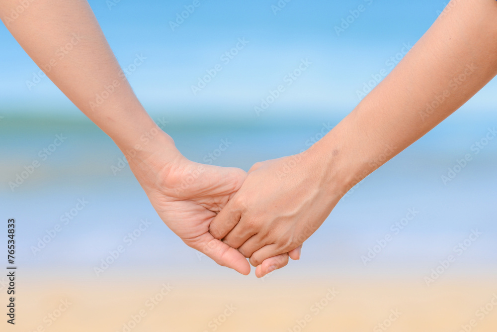 friend holding hand together and the sea background friend holding hand together and the sea background