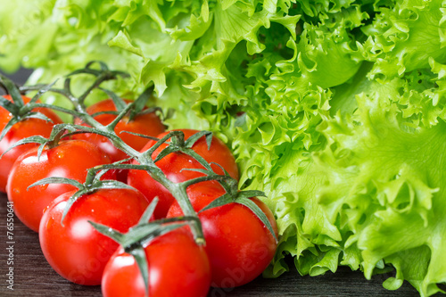 lettuce and tomatoes on wooden background