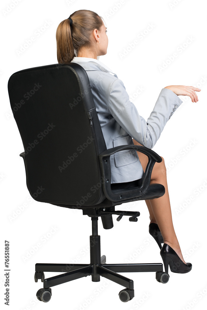 Businesswoman on office chair, making gesture as if talking