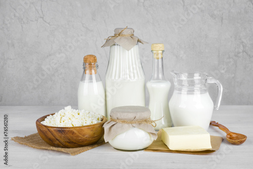 Dairy products on wooden table over vintage abstract background