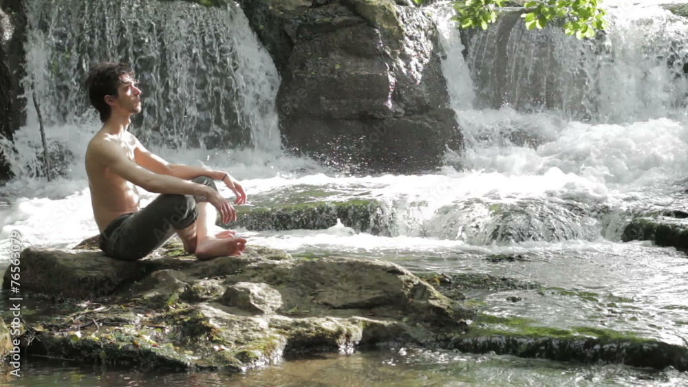 boy meditates sitting on a rock among waterfalls - harmony - peace - into wild boy meditates sitting on a rock among waterfalls - harmony - peace - into wild