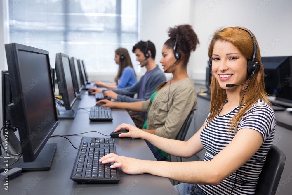 Student smiling at camera in computer class