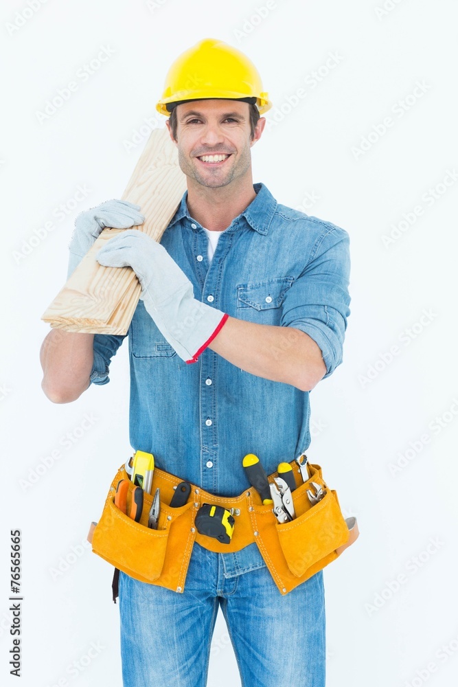 Happy carpenter carrying wooden planks Happy carpenter carrying wooden planks