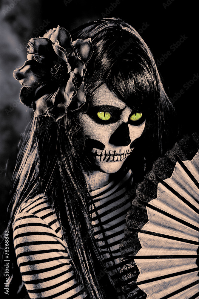 Young woman in day of the dead mask skull face art.