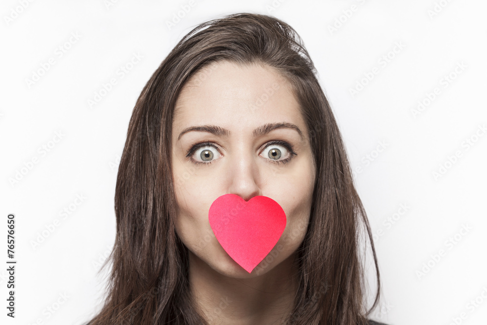 Girl with heart-shaped post-it on her mouth Girl with heart-shaped post-it on her mouth