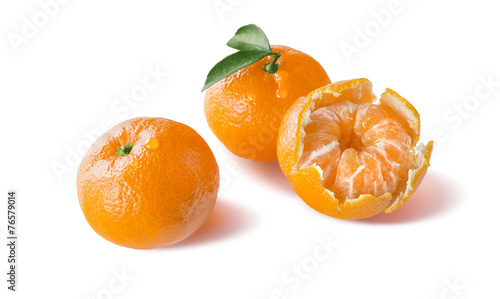 Peeled and whole mandarin with water drops isolated on white
