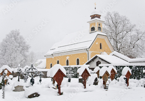 church and graves in winter covered with snow