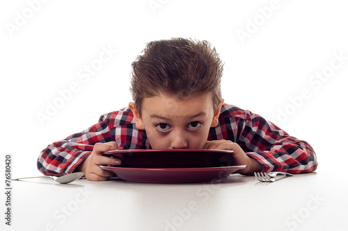 slurping soup out of a plate