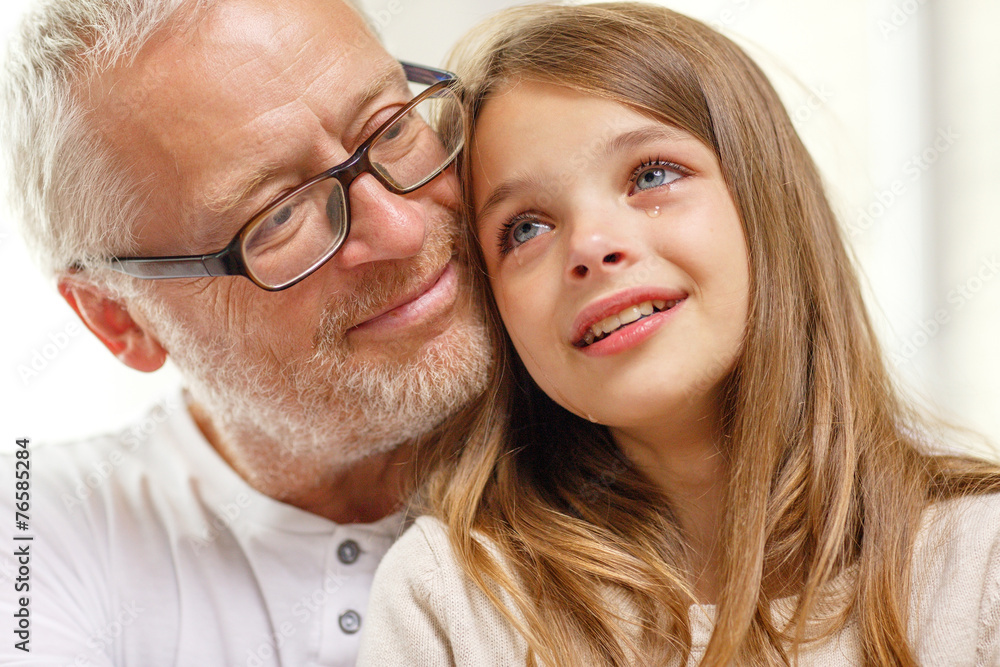 grandfather with crying granddaughter at home grandfather with crying granddaughter at home