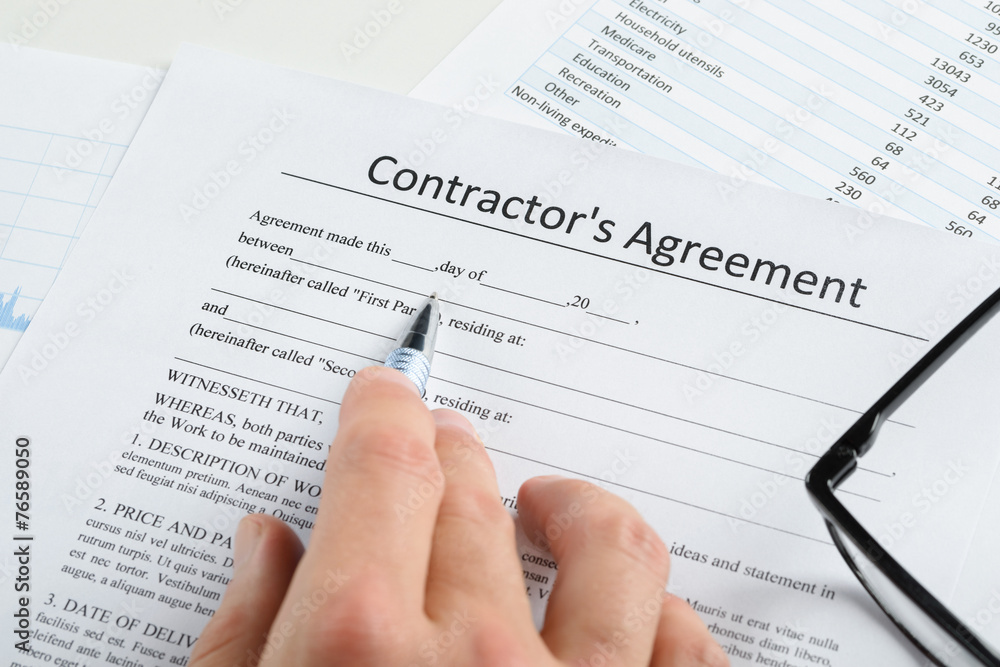 Hand With Pen And Eyeglasses Over Agreement Hand With Pen And Eyeglasses Over Agreement