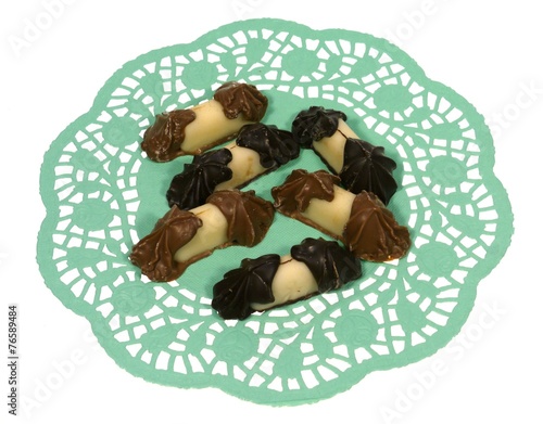 Chocolate and marzipan on a green filigree doily photo