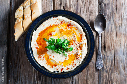 Fresh hummus with parsley and oil.