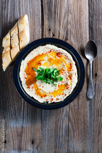 Fresh hummus with parsley and oil.