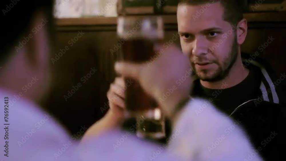 Two men toasting beer in a pub Two men toasting beer in a pub