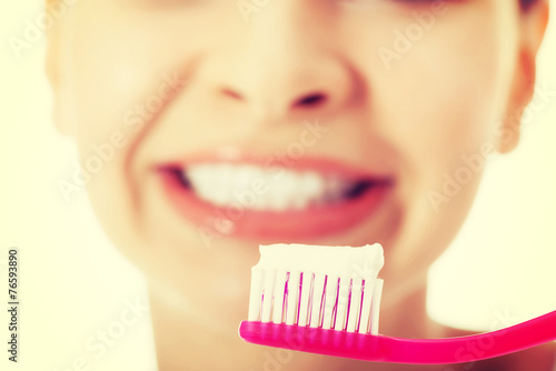 Young woman with toothbrush and paste.