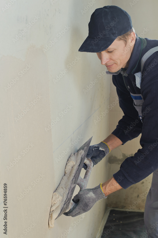 Man gets manually gypsum plaster Man gets manually gypsum plaster