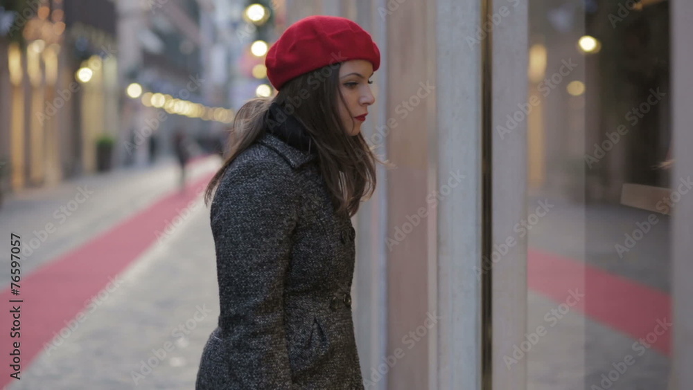 beautiful young woman looking in a shop window beautiful young woman looking in a shop window