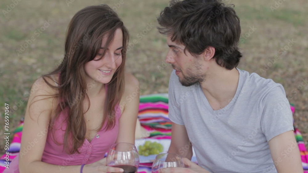a boy and girl toasting and drinking red wine for the anniversary a boy and girl toasting and drinking red wine for the anniversary