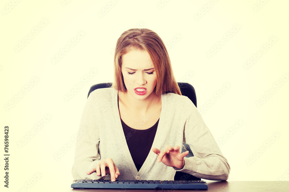 Beautiful woman writing on keyboard with anger. Beautiful woman writing on keyboard with anger.