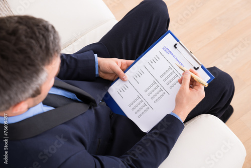 Businessman Filling Customer Survey Form