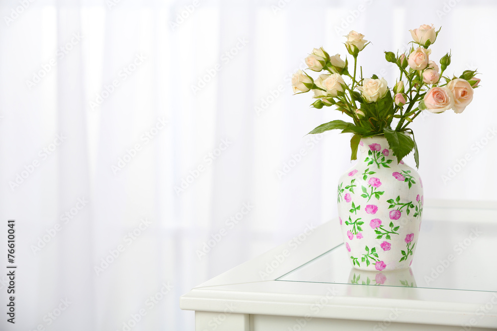 Beautiful bouquet of flowers in vase on window background