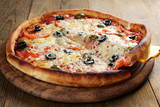 Pizza with cheese on board and wooden table background