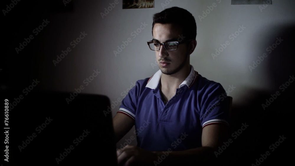 young man using a laptop for chatting on facebook with friends young man using a laptop for chatting on facebook with friends
