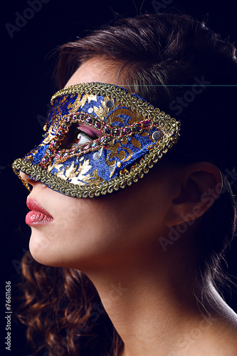 Beautiful girl with masquer...