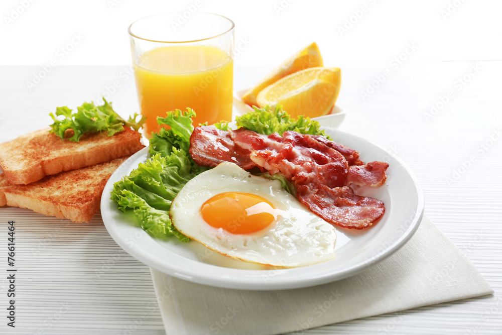 Bacon and eggs on color wooden table background Bacon and eggs on color wooden table background