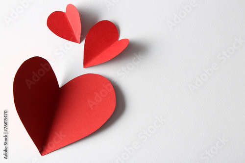Beautiful paper hearts on white paper background, close-up