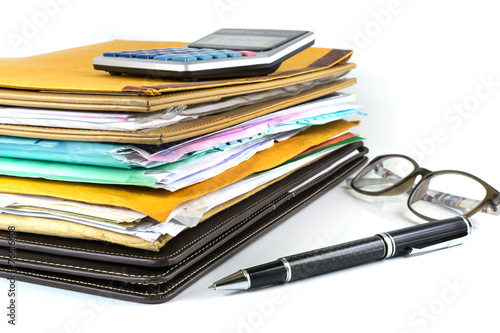 Stack of document with pen and calculator